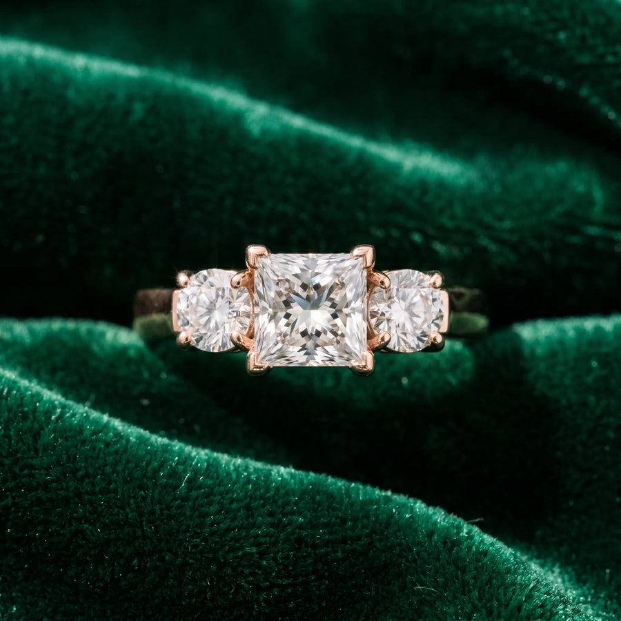 Rose gold Three-Stone Princess Cut Diamond Ring with Round Accent Stones, Prong Setting, and Classic Band