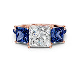 Rose gold Three-Stone Princess Cut Diamond Ring with Round with Blue Sapphire side stone Pavé Band and Prong Setting