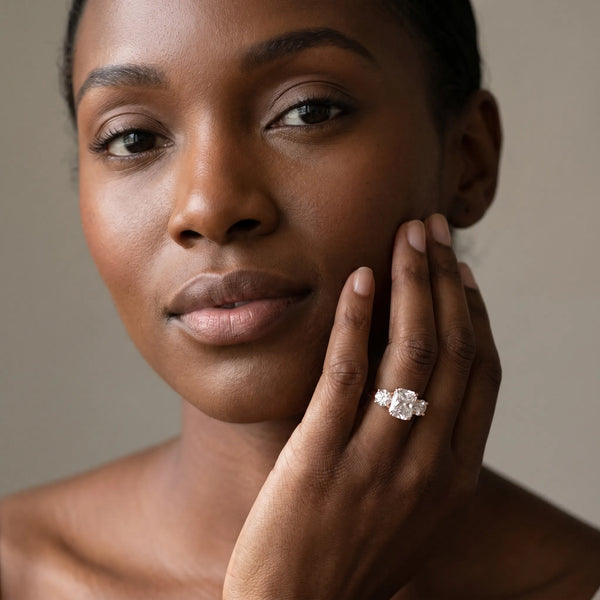 Rose gold Three-Stone Radiant Cut Diamond Ring with Round Accent Stones, Prong Setting, and Classic Band