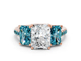 Rose gold Three-Stone Radiant Cut Diamond Ring with Round with Blue Topaz side stone Pavé Band and Prong Setting