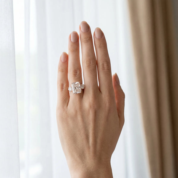 Rose gold Three-Stone Radiant Diamond Engagement Ring with Prong Setting on a Classic Band