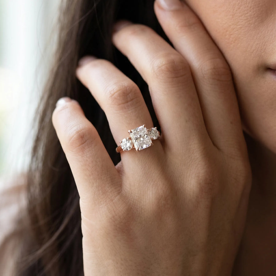 Rose gold Three-Stone Radiant Diamond Engagement Ring with Prong Setting on a Classic Band