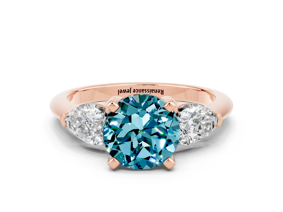Rose gold Three-Stone Round Cut Blue Topaz Ring with Pear Side Stones and Four-Prong Setting