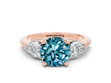 Rose gold Three-Stone Round Cut Blue Topaz Ring with Pear Side Stones and Four-Prong Setting