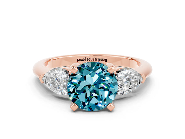 Rose gold Three-Stone Round Cut Blue Topaz Ring with Pear Side Stones and Four-Prong Setting