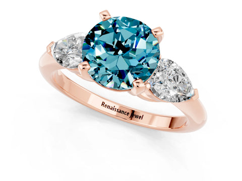 Rose gold Three-Stone Round Cut Blue Topaz Ring with Pear Side Stones and Four-Prong Setting_1