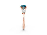 Rose gold Three-Stone Round Cut Blue Topaz Ring with Pear Side Stones and Four-Prong Setting_2