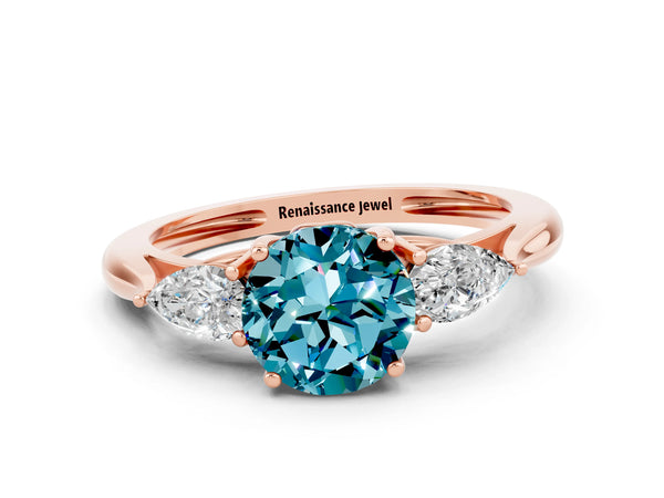 Rose gold Three-Stone Round Cut Blue Topaz Ring with Pear  Side Stones in Four-Prong Setting