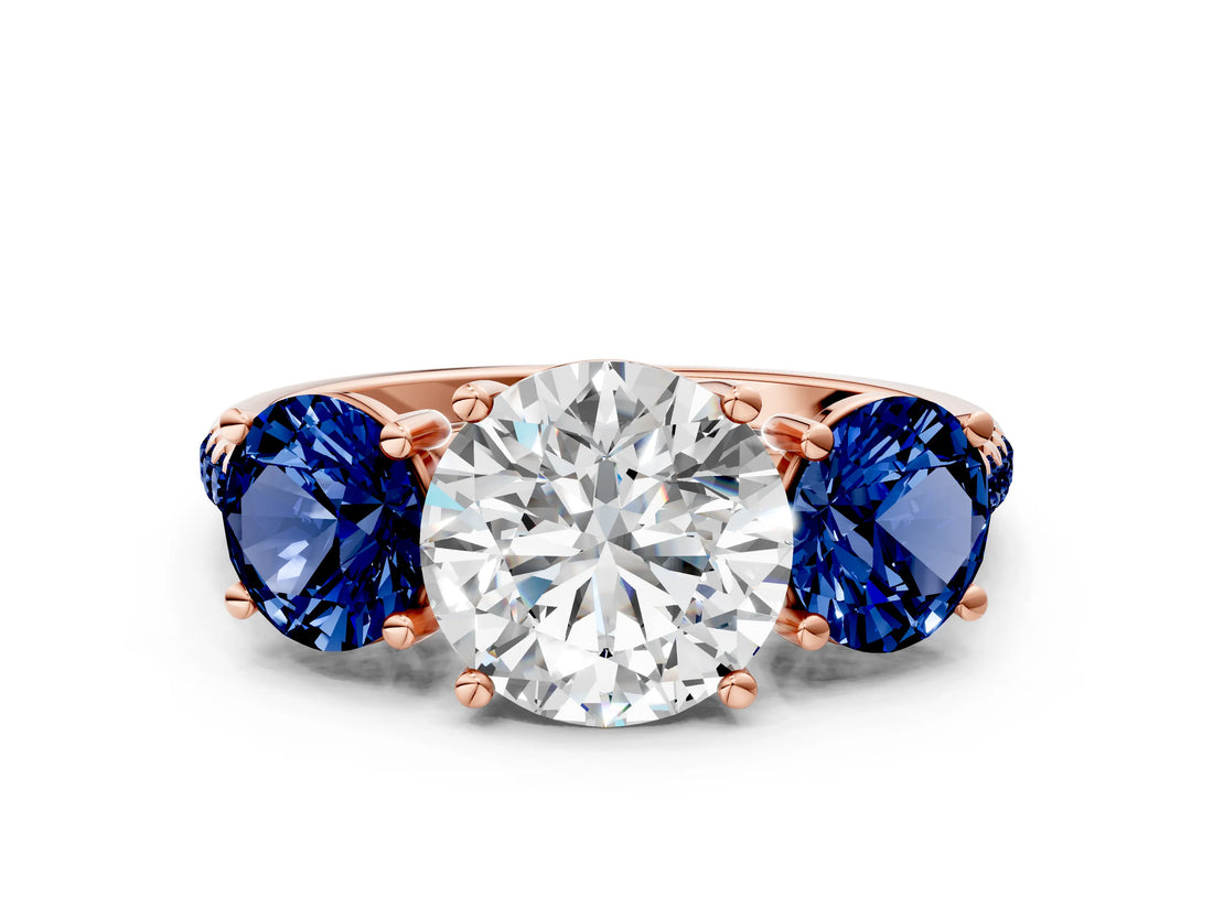 Rose gold Three-Stone Round Cut Diamond Ring with Round with Blue Sapphire side stone Pavé Band and Prong Setting