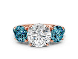 Rose gold Three-Stone Round Cut Diamond Ring with Round with Blue Topaz side stone Pavé Band and Prong Setting