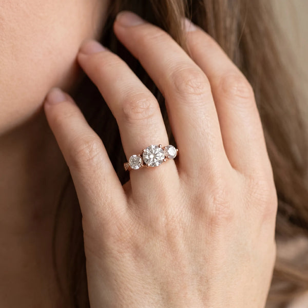 Rose gold Three-Stone Round Diamond Engagement Ring with Prong Setting on a Classic Band