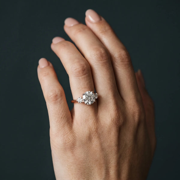 Rose gold Three-Stone Round Solitaire Ring with Tapered Band and Four-Prong Setting