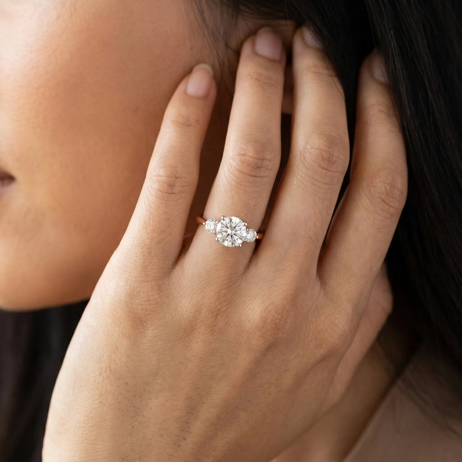 Rose gold Three-Stone Round Solitaire Ring with Tapered Band and Four-Prong Setting