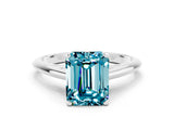 Silver Emerald Cut Blue Topaz Solitaire Engagement Ring with Cathedral Setting and Four-Prong Mount