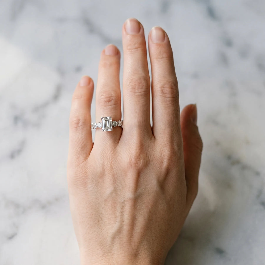 White gold Emerald Cut Diamond Prong Setting with Side Stones on a Pave Band