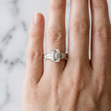 Silver Emerald Cut Diamond Solitaire Ring with Engraved Band and Four-Prong Setting_96