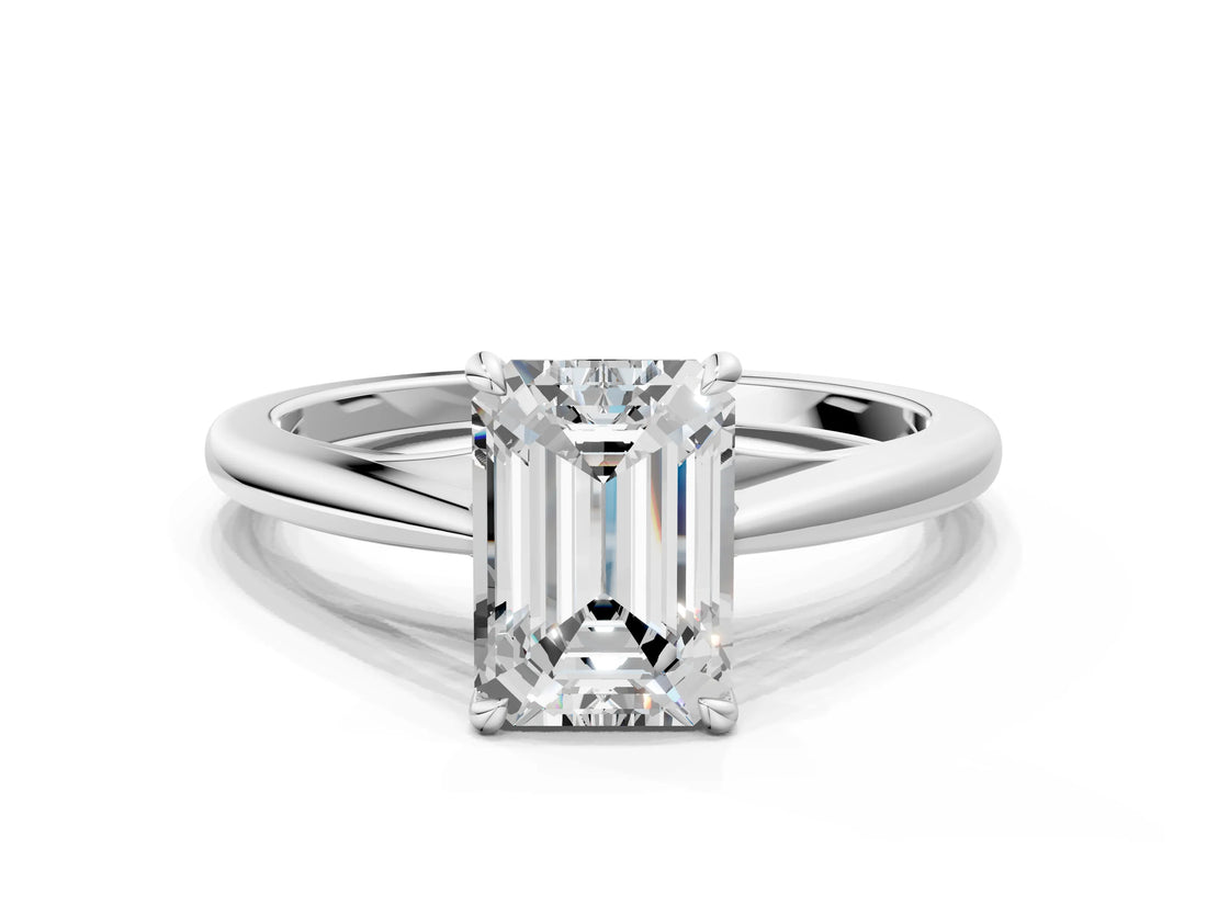 Silver Emerald Solitaire Engagement Ring with Four-Prong Setting and Classic Band