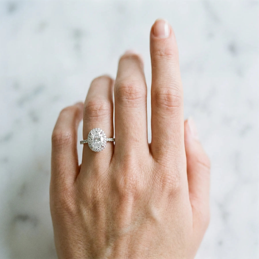 White gold Oval Halo Diamond Engagement Ring with Pavé Band and Four-Prong Setting