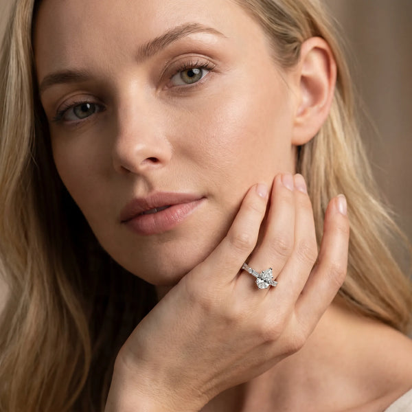 White gold Pear Cut Diamond Solitaire with Side Baguettes and Channel Set Band