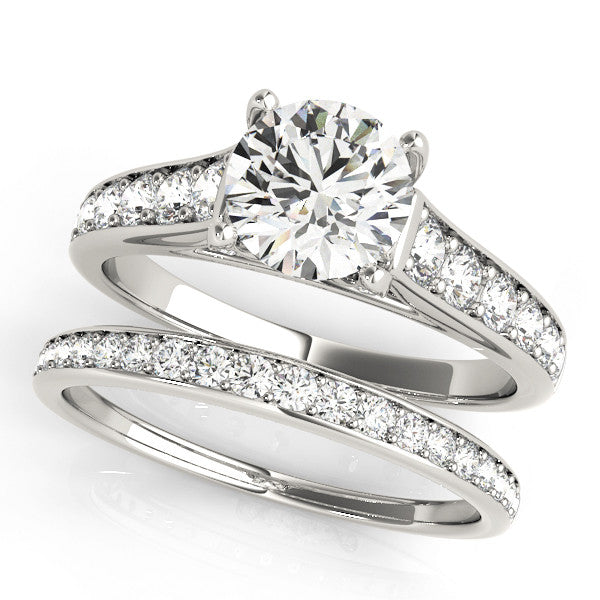 Silver Round Brilliant Cut Diamond Engagement Ring with Pavé Band and Four-Prong Setting