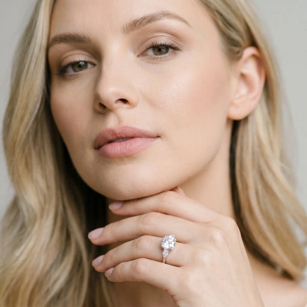 White gold Round Brilliant Diamond Solitaire Ring with Pear Side Stones and Four-Prong Setting