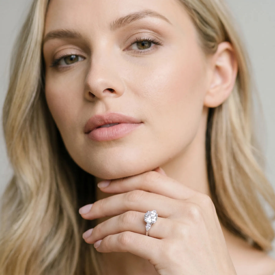 White gold Round Brilliant Diamond Solitaire Ring with Pear Side Stones and Four-Prong Setting