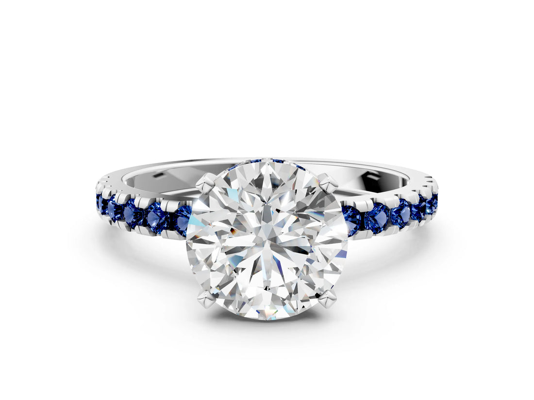 Silver Round Cut Diamond Solitaire Ring with Round with Blue Sapphire side stone Pavé Band and Four-Prong Setting_12