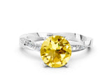 Silver Round Cut Yellow Sapphire Engagement Ring with Side Stone Accents and Four-Prong Setting_24