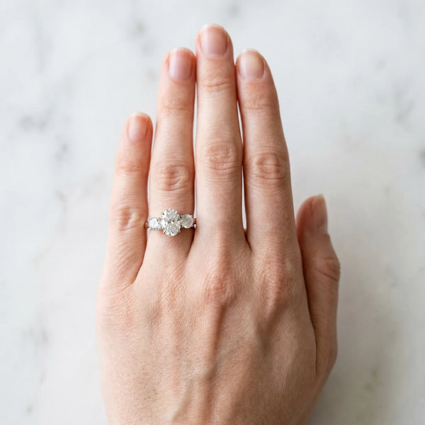 White gold Three-Stone Oval Diamond Ring with Round Side Stones, Classic Band, and Four-Prong Setting