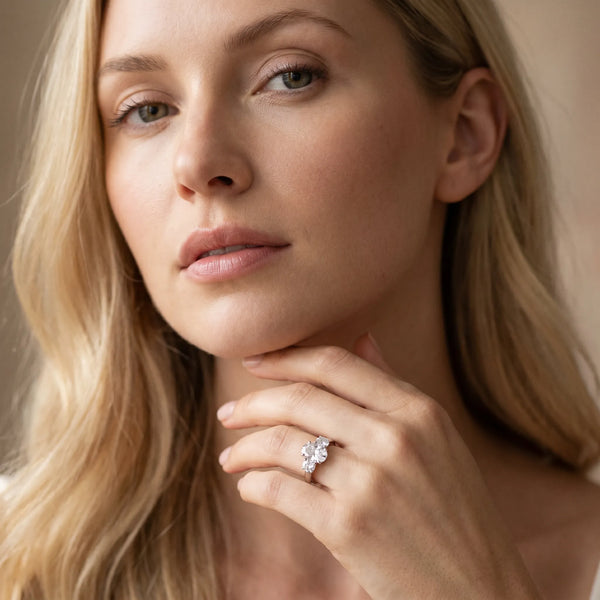White gold Three-Stone Oval Diamond Ring with Round Side Stones, Classic Band, and Four-Prong Setting