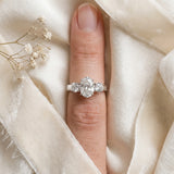 Silver Three-Stone Oval Diamond Ring with Round Side Stones, Classic Band, and Four-Prong Setting_60
