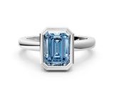 White gold Bezel Set Fancy Blue Emerald Cut Solitaire Engagement Ring with Classic Band