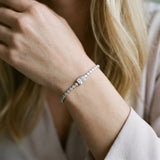 White gold Bezel-Set Round Diamond Tennis Bracelet with Radiant Center Diamond