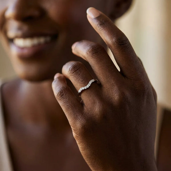 White gold Curved Diamond Wedding Band with Round Cut Stones and Shared Prong Setting