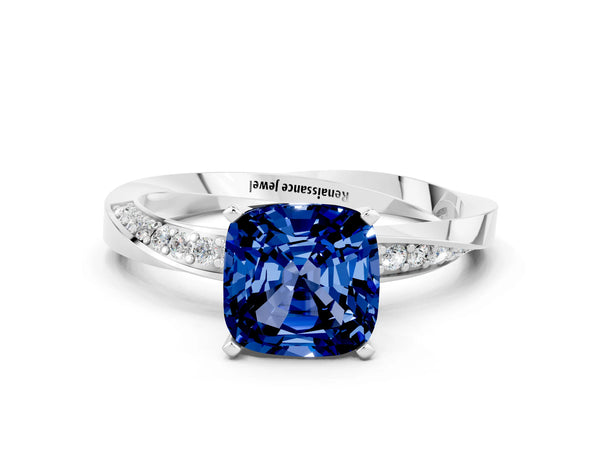 Platinum Cushion Cut Blue Sapphire Engagement Ring with Side Stone Accents and Four-Prong Setting