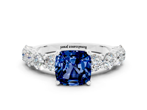 Platinum Cushion Cut Blue Sapphire Prong Setting with Side Stones on a Pave Band