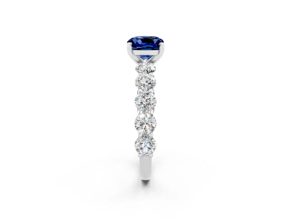 Silver Cushion Cut Blue Sapphire Prong Setting with Side Stones on a Pave Band
