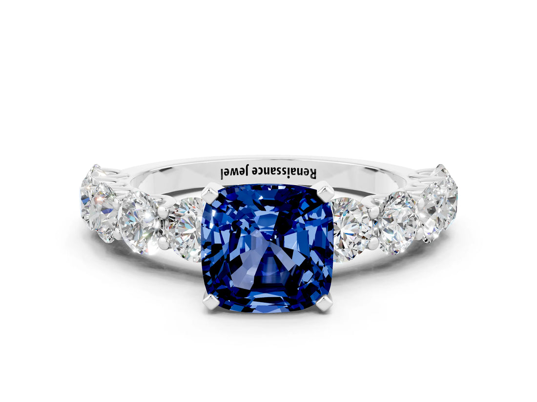 White gold Cushion Cut Blue Sapphire Prong Setting with Side Stones on a Pave Band