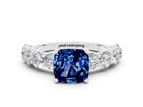 White gold Cushion Cut Blue Sapphire Prong Setting with Side Stones on a Pave Band