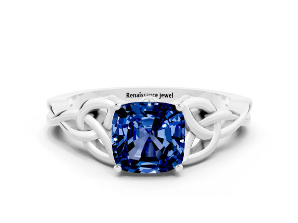 Platinum Cushion Cut Blue Sapphire Solitaire Engagement Ring with Celtic Knot Band and Four-Prong Setting