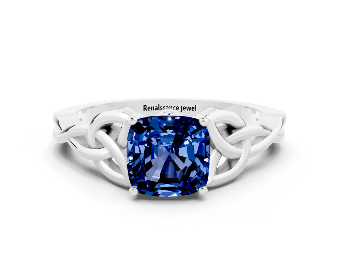 White gold Cushion Cut Blue Sapphire Solitaire Engagement Ring with Celtic Knot Band and Four-Prong Setting