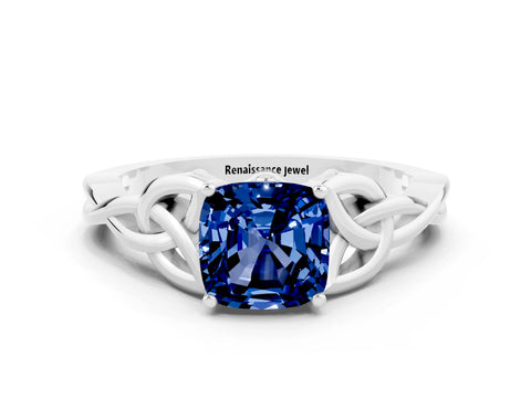 White gold Cushion Cut Blue Sapphire Solitaire Engagement Ring with Celtic Knot Band and Four-Prong Setting