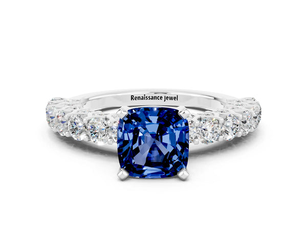 Platinum Cushion Cut Blue Sapphire Solitaire Ring with Shared Prong Pavé Band and Four-Prong Setting