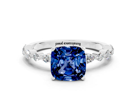 White gold Cushion Cut Blue Sapphire Solitaire with Side Stones on a Pavé Band and Four-Prong Setting