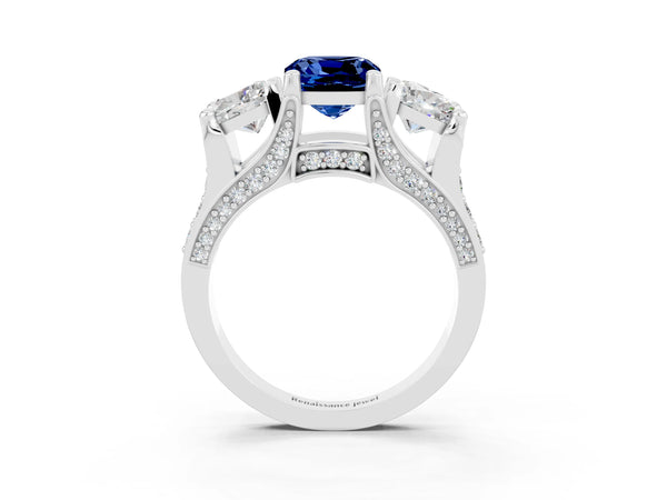 Platinum Cushion Cut Blue Sapphire Three-Stone Ring with Channel Set Band and Four-Prong Setting