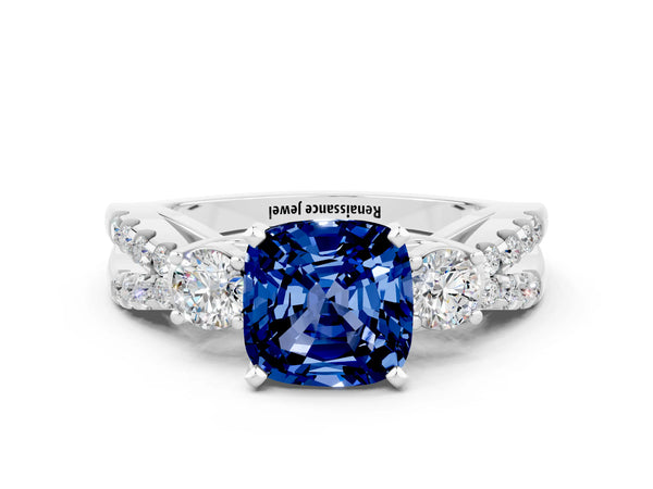 Platinum Cushion Cut Blue Sapphire Three-Stone Ring with Pavé Split Shank and Four-Prong Setting