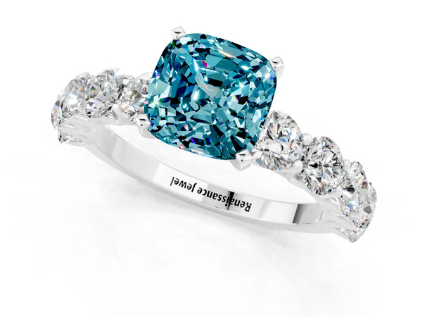 Platinum Cushion Cut Blue Topaz Prong Setting with Side Stones on a Pave Band