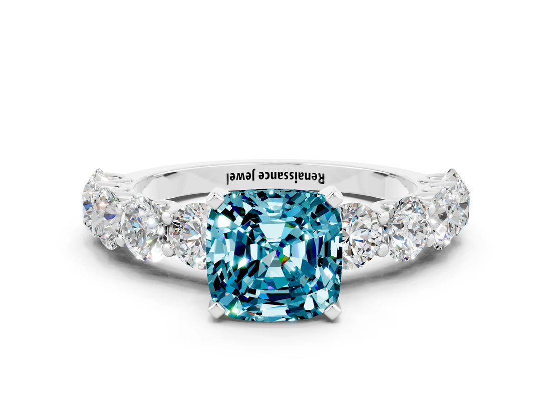 White gold Cushion Cut Blue Topaz Prong Setting with Side Stones on a Pave Band