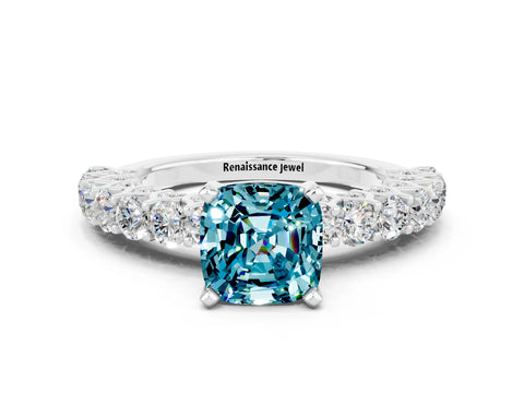 White gold Cushion Cut Blue Topaz Solitaire Ring with Shared Prong Pavé Band and Four-Prong Setting