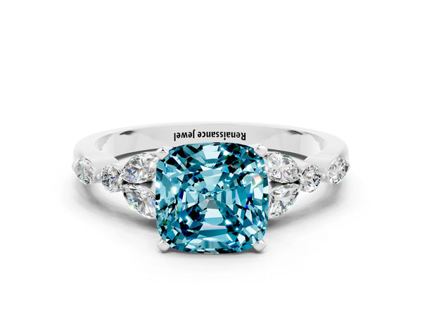Silver Cushion Cut Blue Topaz Solitaire Ring with Side Stones and Four-Prong Setting